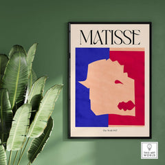 Matisse The Wolf 1947 Papiers Découpés Poster Print framed on wall with plants, featuring bold colors and abstract design.