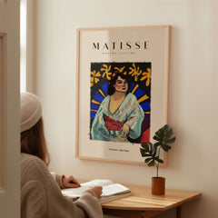 Matisse Art Prints -  Woman Robe Abstract Stained Glass Effect Poster displayed on a wall with a woman admiring it.