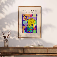 Matisse Art Prints - Yellow Cat with Fishbowl Geometric Poster displayed on a wall above a wooden console table.