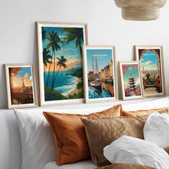 Maui Hawaii Travel Poster | Scenic Tropical Bay View Wall Art Print displayed among other travel posters on a stylish sofa.