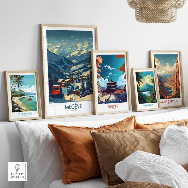 Collection of framed travel posters featuring Megève, Beijing, Philippines, Costa Rica, and Grand Canyon displayed on a shelf.