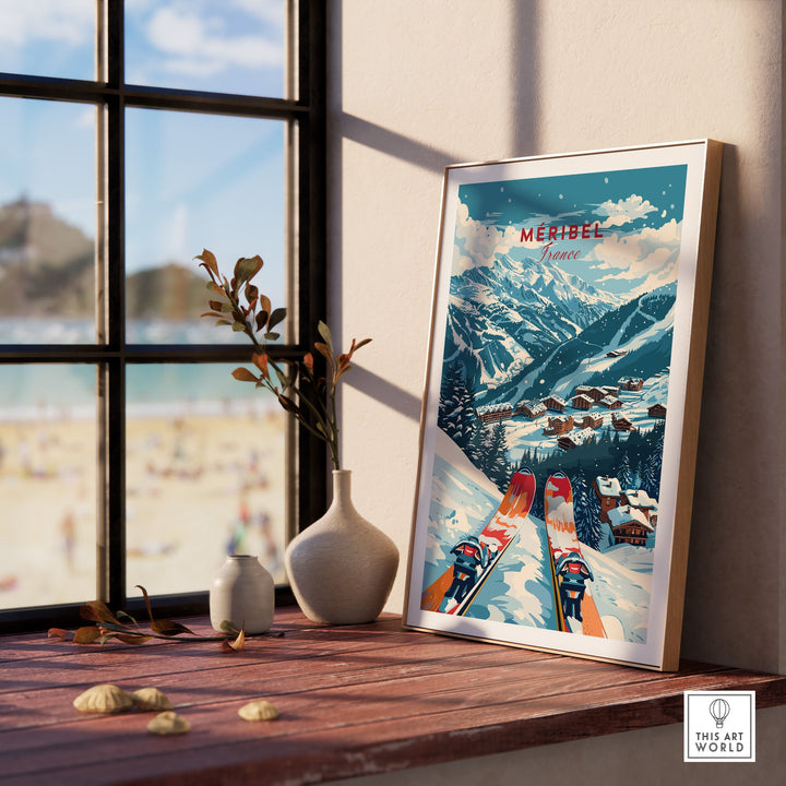 Vintage Megève ski poster in frame, showcasing snowy mountain landscape and village, against a sunny window backdrop.