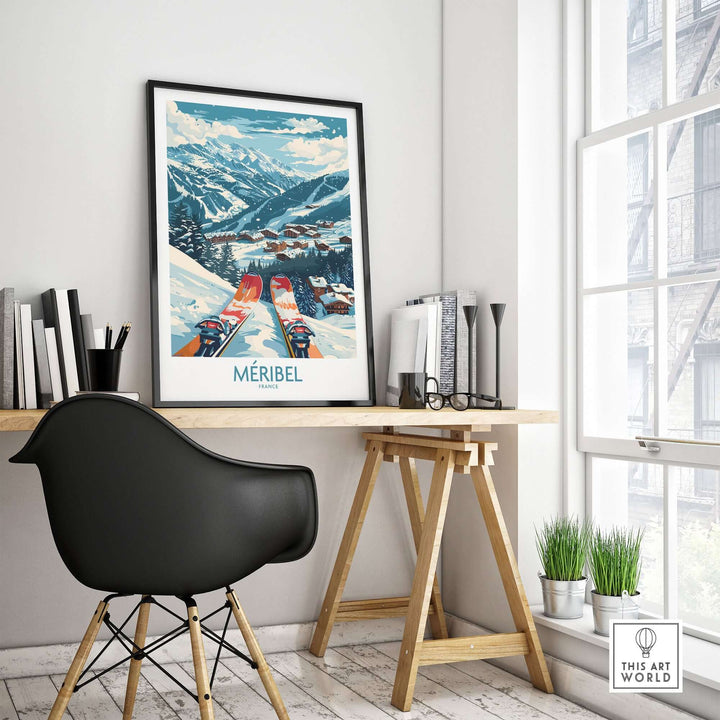 Modern office with Méribel ski print wall art, books on a wooden desk, and a black chair. Bright window and minimalist décor.