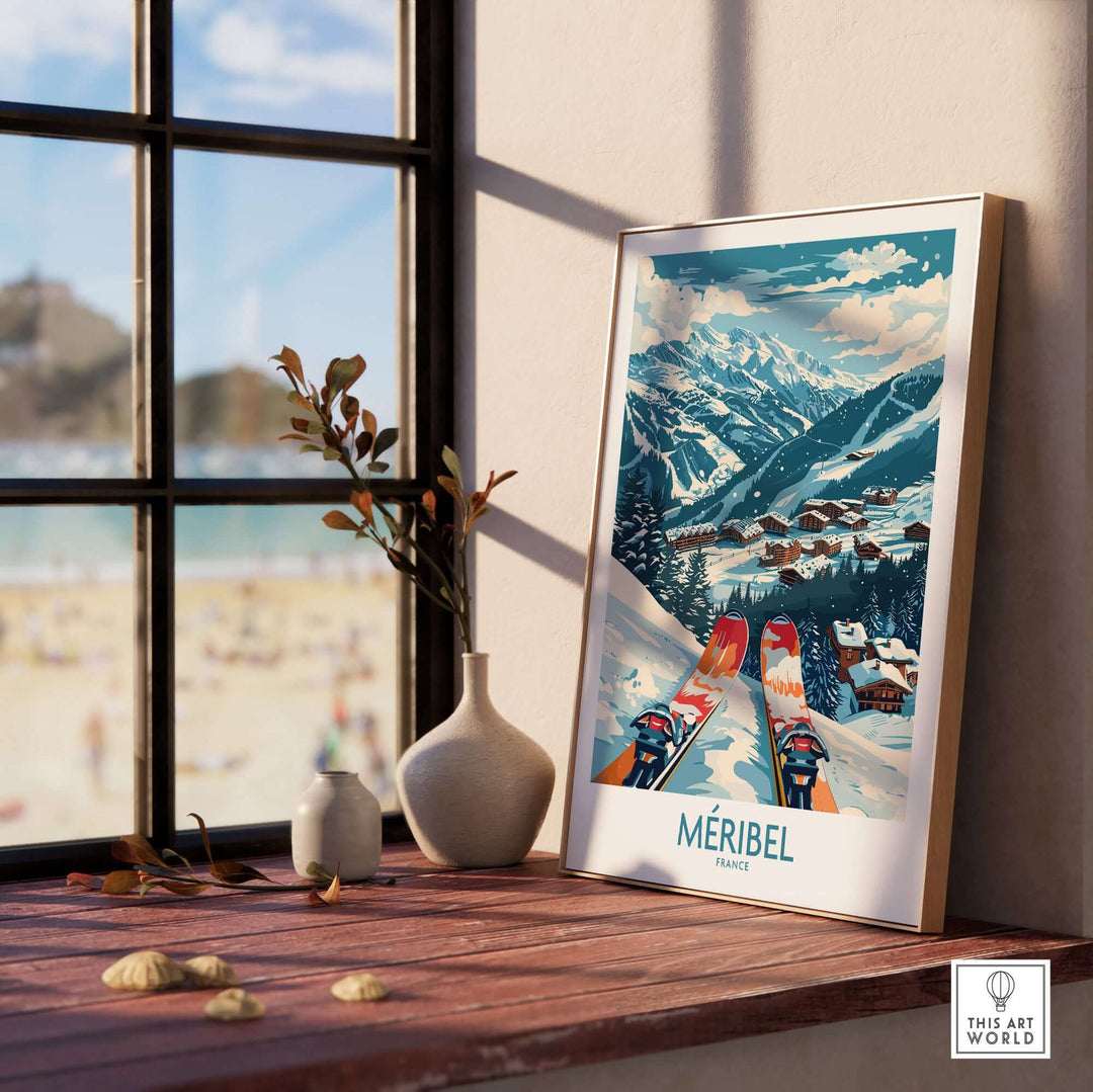 Framed Meribel ski print displayed on windowsill with mountain view in background.