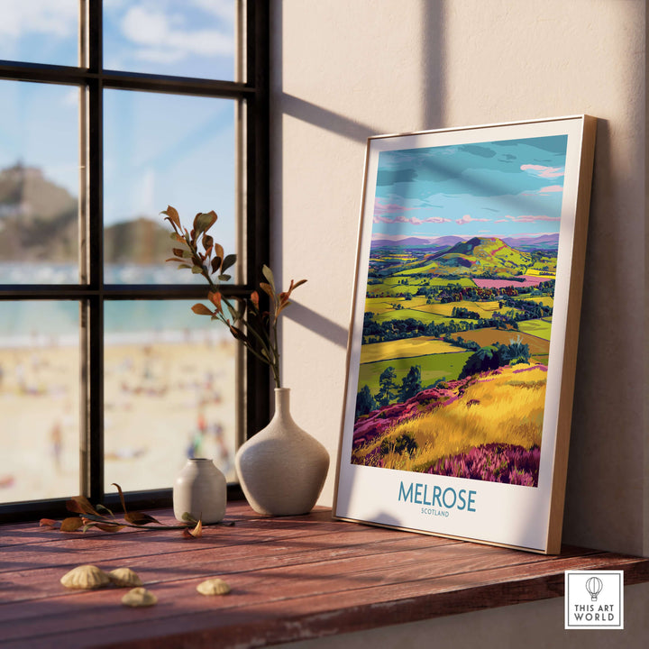 Melrose Scotland Eildon Hills travel print in a bright interior, showcasing vibrant landscape art on a wooden table.