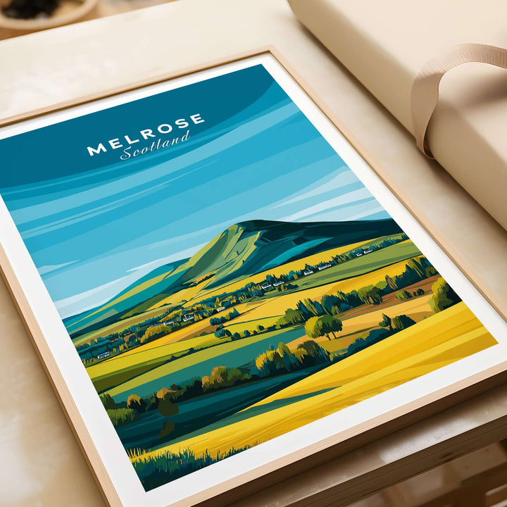 Melrose Scotland travel poster print featuring Eildon Hills and vibrant landscape in yellow and green under a blue sky.
