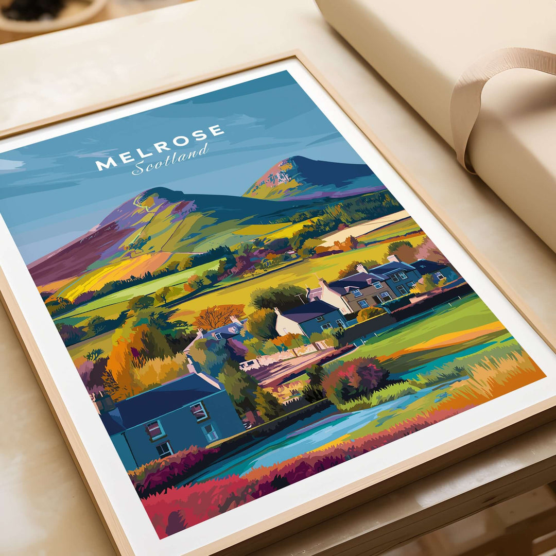 Melrose Scotland travel print depicting village houses and Eildon Hills in vibrant colors, perfect for wall art.