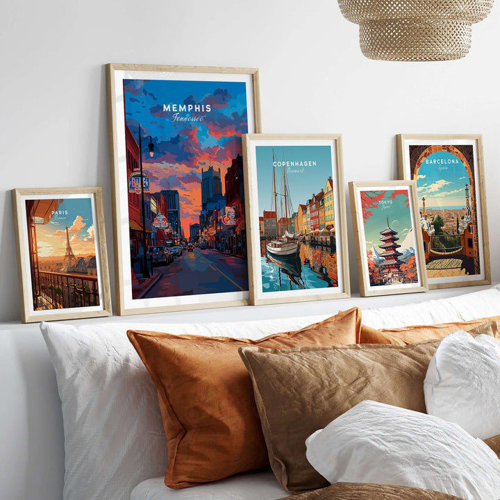 Framed Memphis poster and travel prints on a sofa, showcasing vibrant cityscapes and Southern charm.