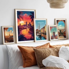 Miami Travel Print displayed among various travel posters on a cozy bed with decorative pillows.