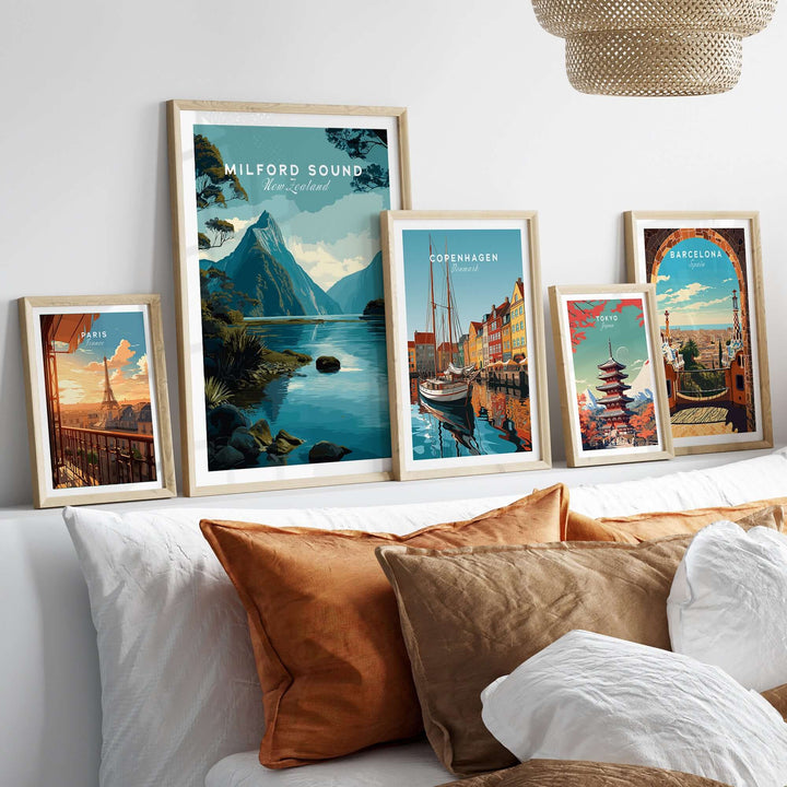 Framed travel posters including Milford Sound, Copenhagen, and Barcelona on a cozy living room wall.