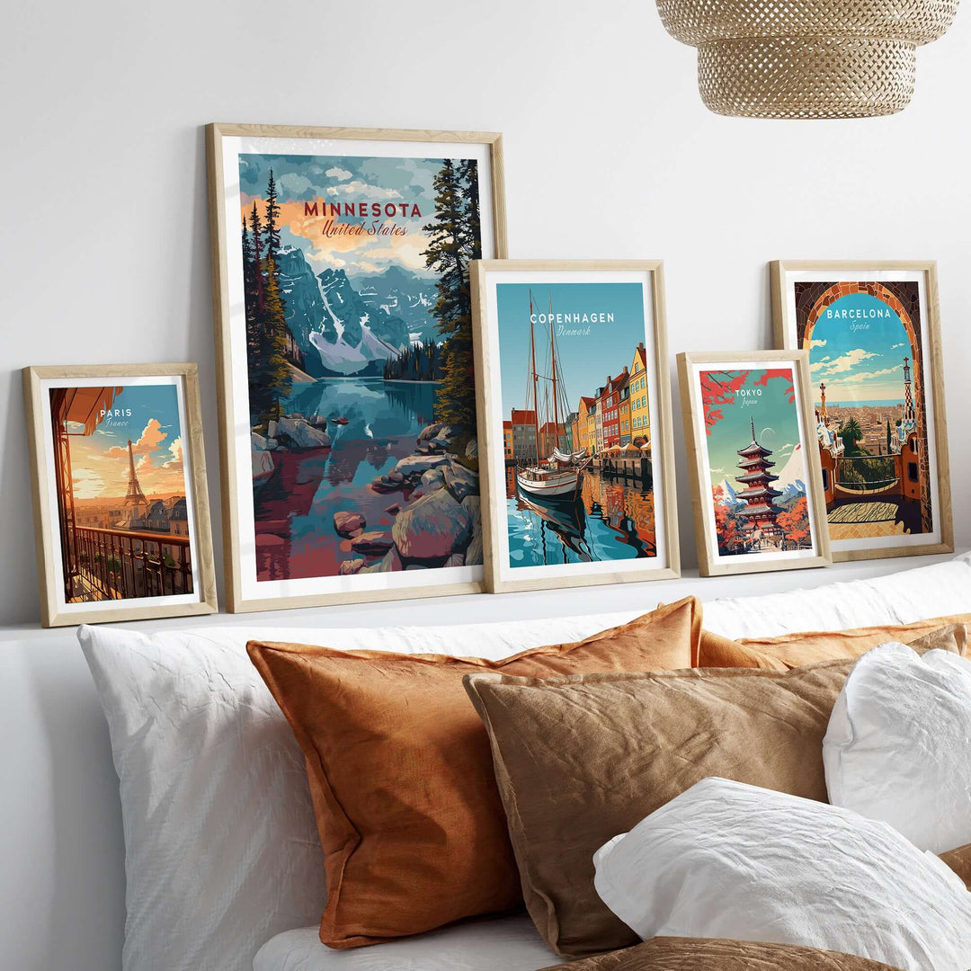 Framed Minnesota landscape poster and travel art collection on a sofa with decorative pillows.