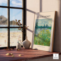 Monet Banks of the Seine Vétheuil River Landscape Art Print Poster displayed on a sunny windowsill with decor.