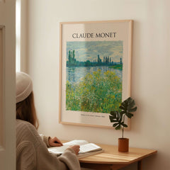 Monet Banks of the Seine Vétheuil River Landscape Art Print Poster displayed in a cozy interior with a person reading.