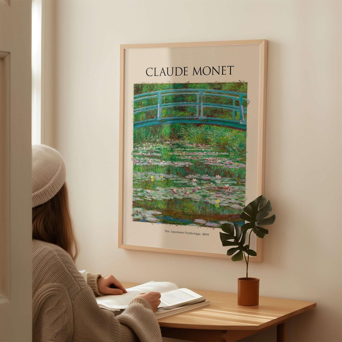 Monet Japanese Footbridge Water Lilies Giverny Garden Poster Art Print displayed in a cozy room with a person reading.