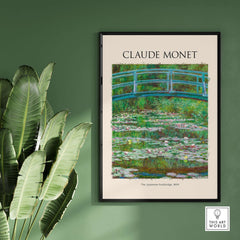 Monet Japanese Footbridge Water Lilies Giverny Garden Poster Art Print framed on a green wall with tropical plants.