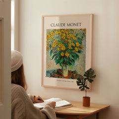 Monet Jerusalem Artichoke Flowers Still Life Floral Art Print Poster displayed on wall with woman studying nearby.