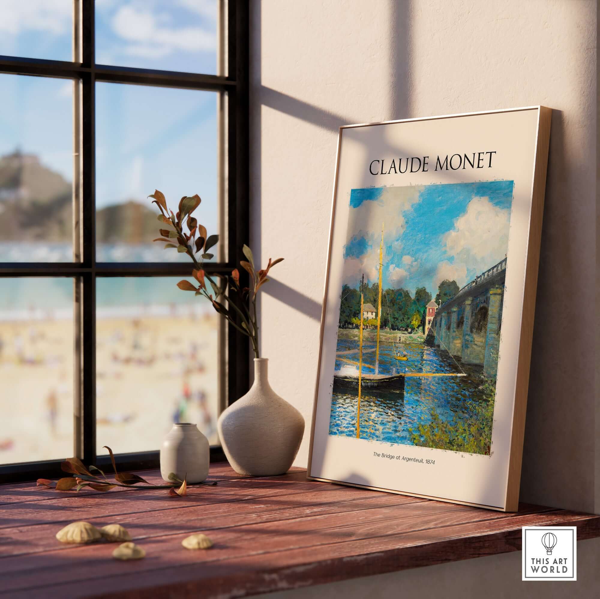 Monet The Bridge at Argenteuil Seine River Landscape Art Print Poster displayed on a wooden table near a window.