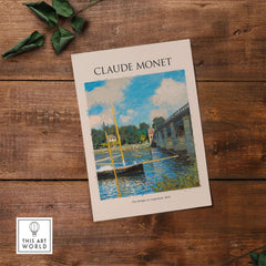 Monet The Bridge at Argenteuil Seine River Landscape Art Print Poster on wooden table.