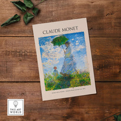 Monet Woman with Parasol Madame Monet Son Impressionist Art Print Poster displayed on wooden table.