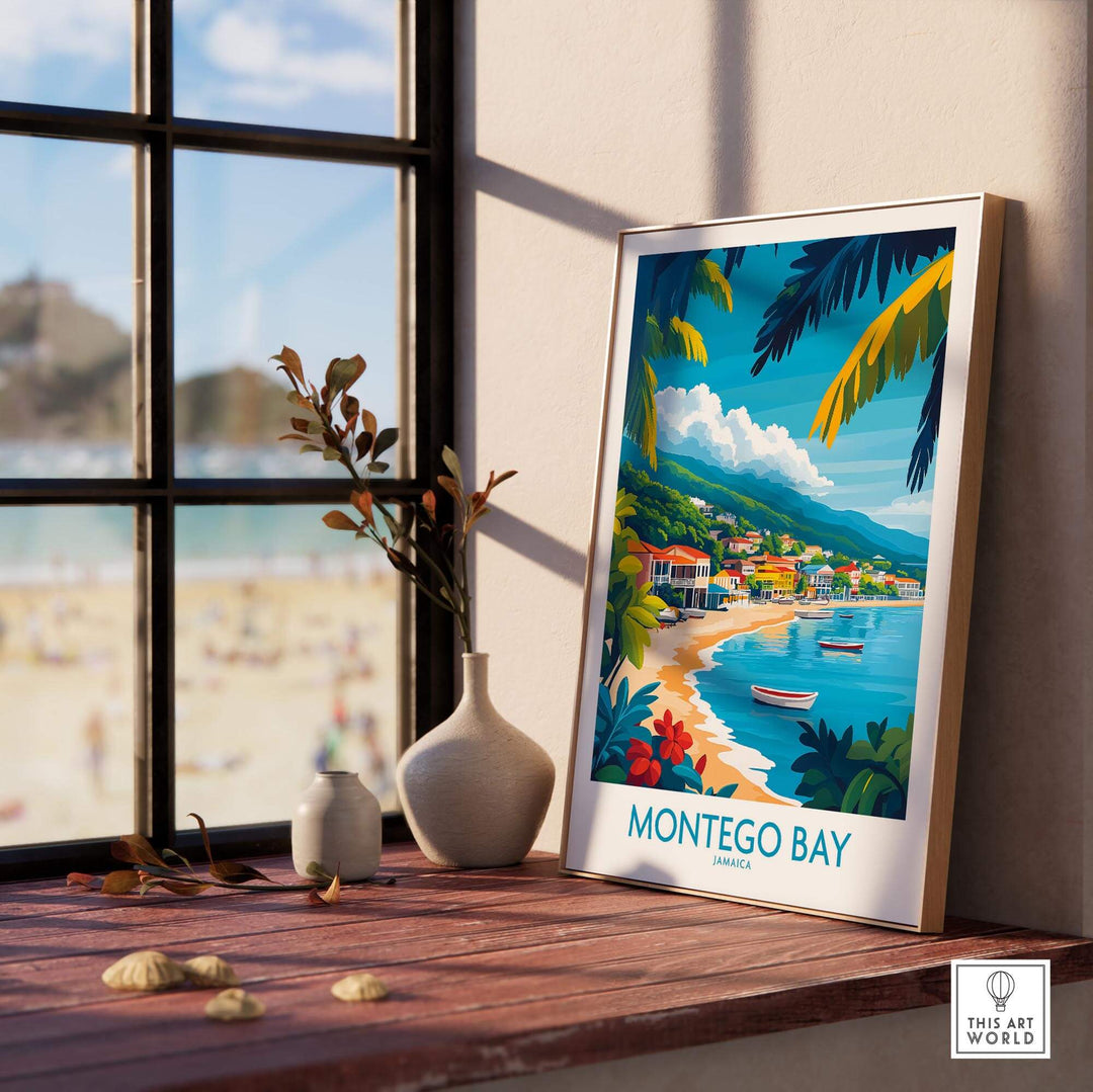 Montego Bay poster featuring vibrant coastal scenery and tropical foliage, displayed on a windowsill with a beach view.