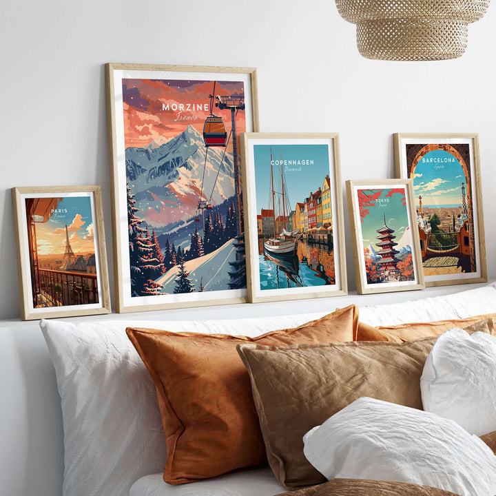 Collection of art prints featuring Morzine ski poster, Copenhagen, Barcelona, and more displayed above a sofa with cushions.