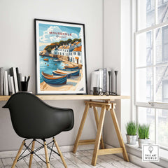 Mousehole Travel Print Cornwall displayed in a modern room with wooden desk and black chair, showcasing coastal decor.