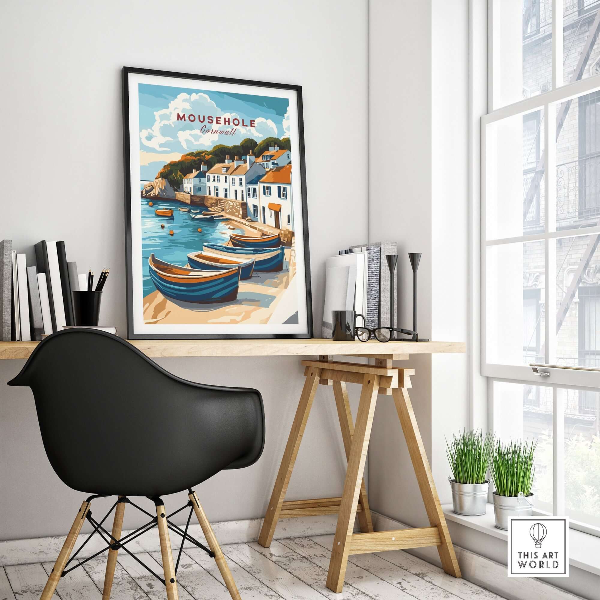 Mousehole Travel Print Cornwall displayed in a modern room with wooden desk and black chair, showcasing coastal decor.