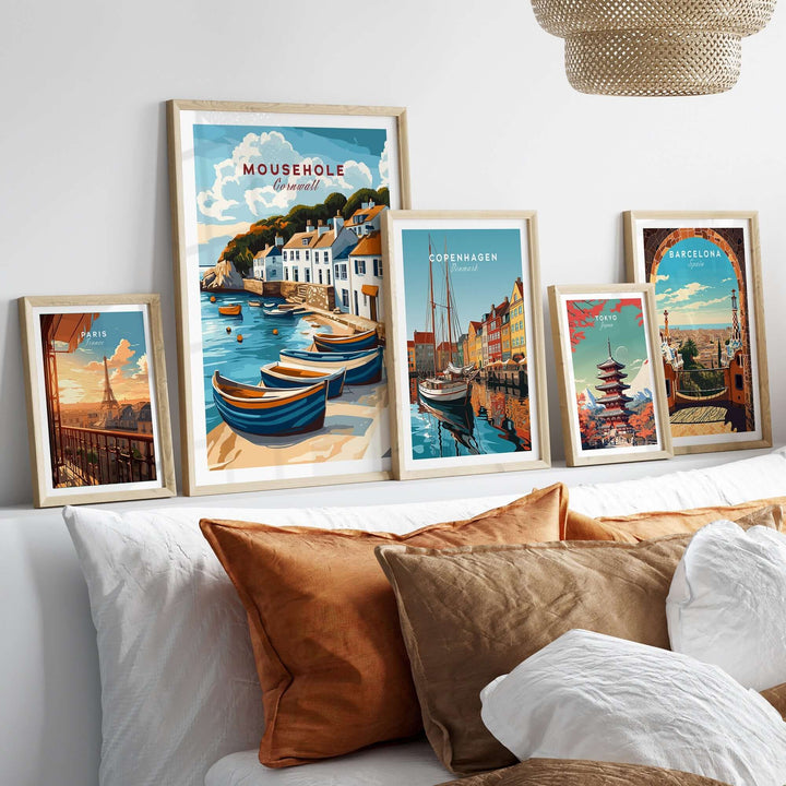 Gallery wall featuring coastal-inspired travel prints, including Mousehole Travel Print, showcasing scenic seaside villages and global landmarks.