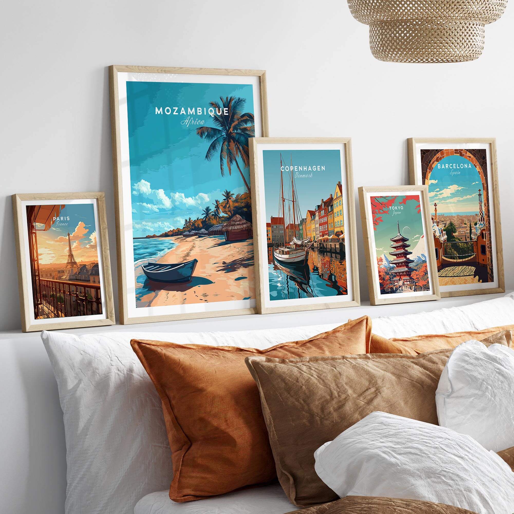 Mozambique Travel Poster displayed among other travel posters on a shelf with decorative pillows.