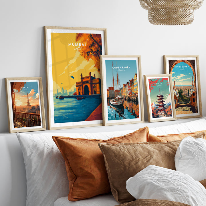 Vibrant Mumbai Gateway of India poster among framed city prints on a cozy sofa decor.