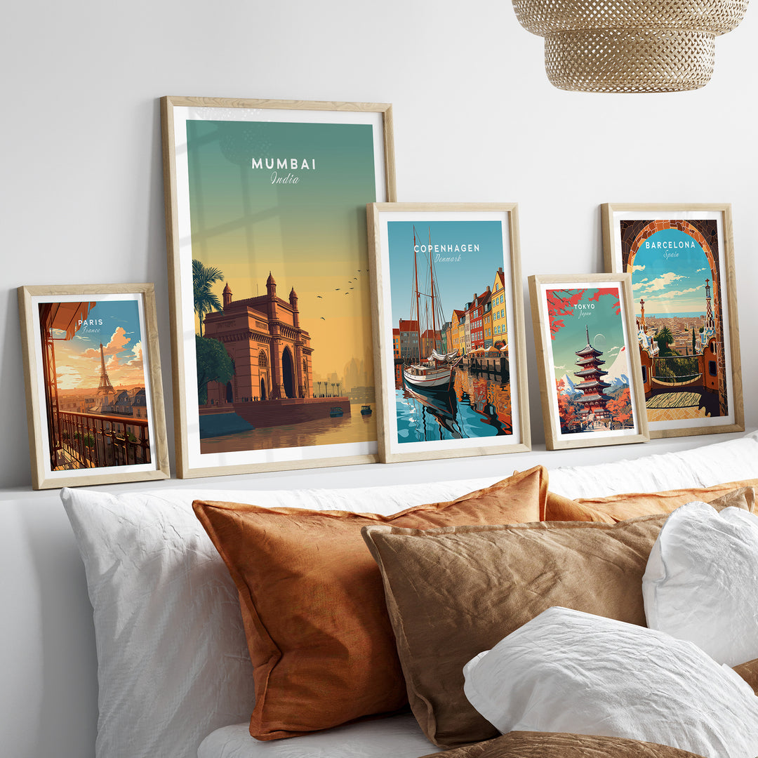 Framed posters of Mumbai, Copenhagen, and Barcelona displayed on a stylish wall with a cozy sofa.