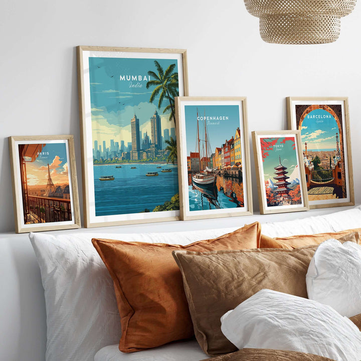 Mumbai Marine Drive palm trees wall art among framed coastal city prints on a modern couch.