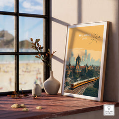 Mumbai India Railway Station & Skyline Print - Iconic Indian City Poster displayed next to a vase on a sunlit wooden table.