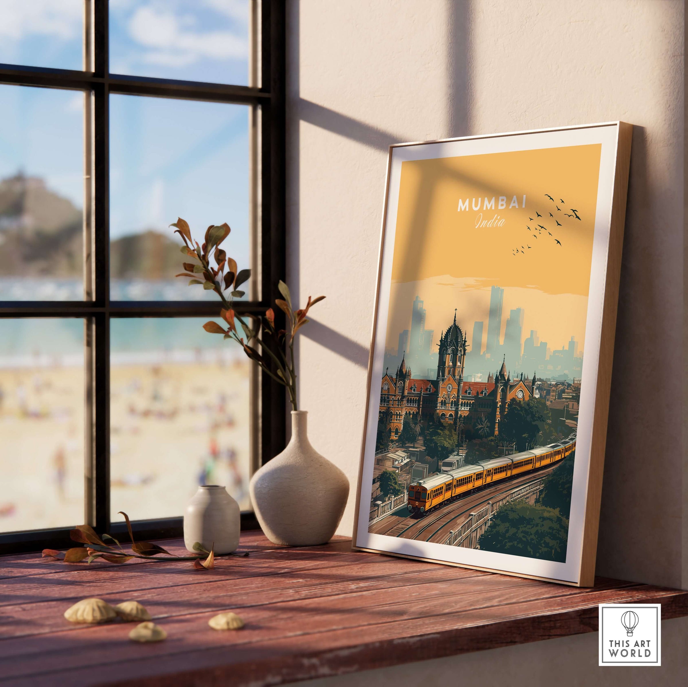 Mumbai India Railway Station & Skyline Print - Iconic Indian City Poster displayed next to a vase on a sunlit wooden table.