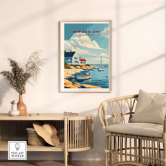 New England Travel Poster showcasing coastal beauty with boats, house, and serene sky in a stylish interior setting.