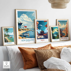 New England Travel Print displayed among various travel posters on a cozy wall, highlighting coastal landscapes.