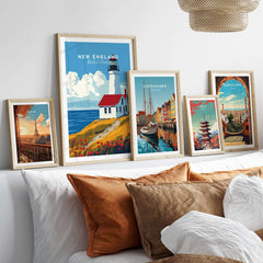 New England Wall Art featuring framed prints of a lighthouse and various travel destinations.