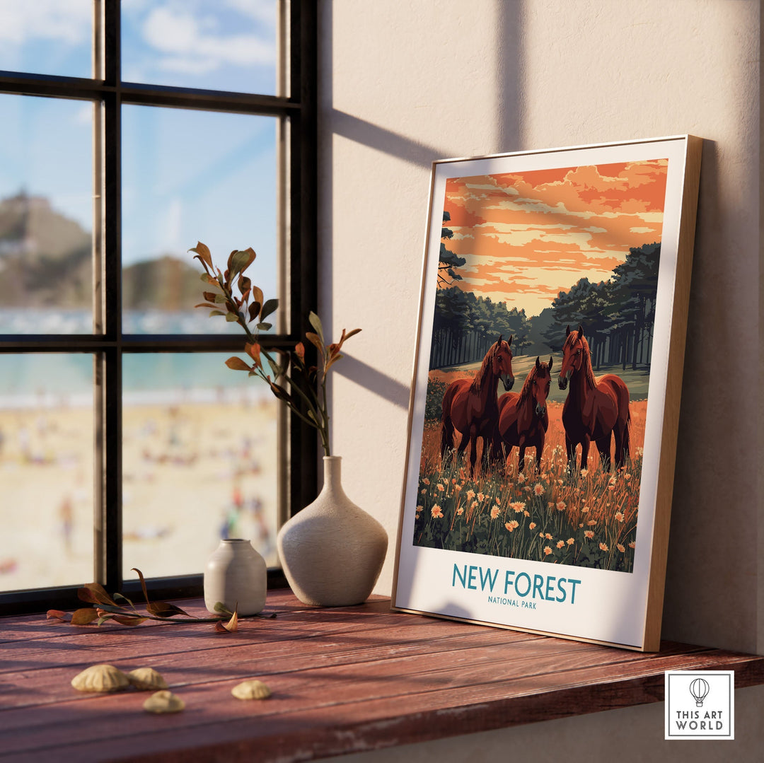 New Forest Print poster featuring horses in a scenic UK National Park, displayed on a wooden table by a window with beach view.