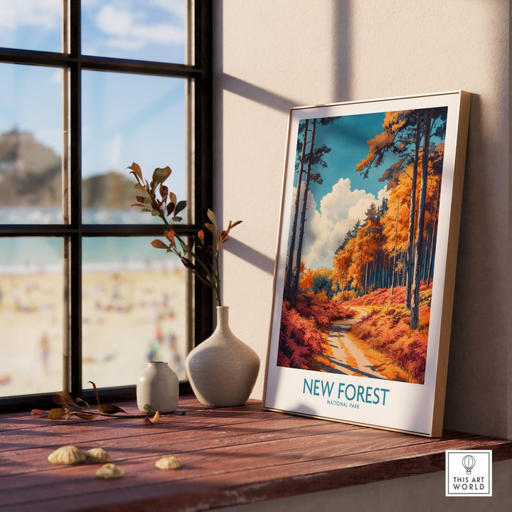 New Forest travel print in frame on sunny windowsill, showcasing vibrant autumn colors and tranquil English landscape.