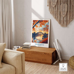 Newcastle Poster England showcasing the Tyne Bridge in a cozy home setting with autumn leaves.