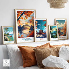Newcastle Poster England displayed among framed travel posters on a stylish interior shelf.