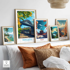 Newcastle upon Tyne Travel Poster displayed among other travel posters on a stylish sofa.