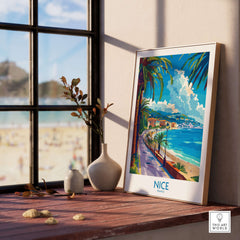 Nice Poster - France displayed on a wooden table near a window, showcasing the beauty of Nice's beach and vibrant colors.