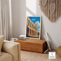 Nimes France Travel Print showcased in a stylish living room setting, perfect for travel enthusiasts and wall art lovers.