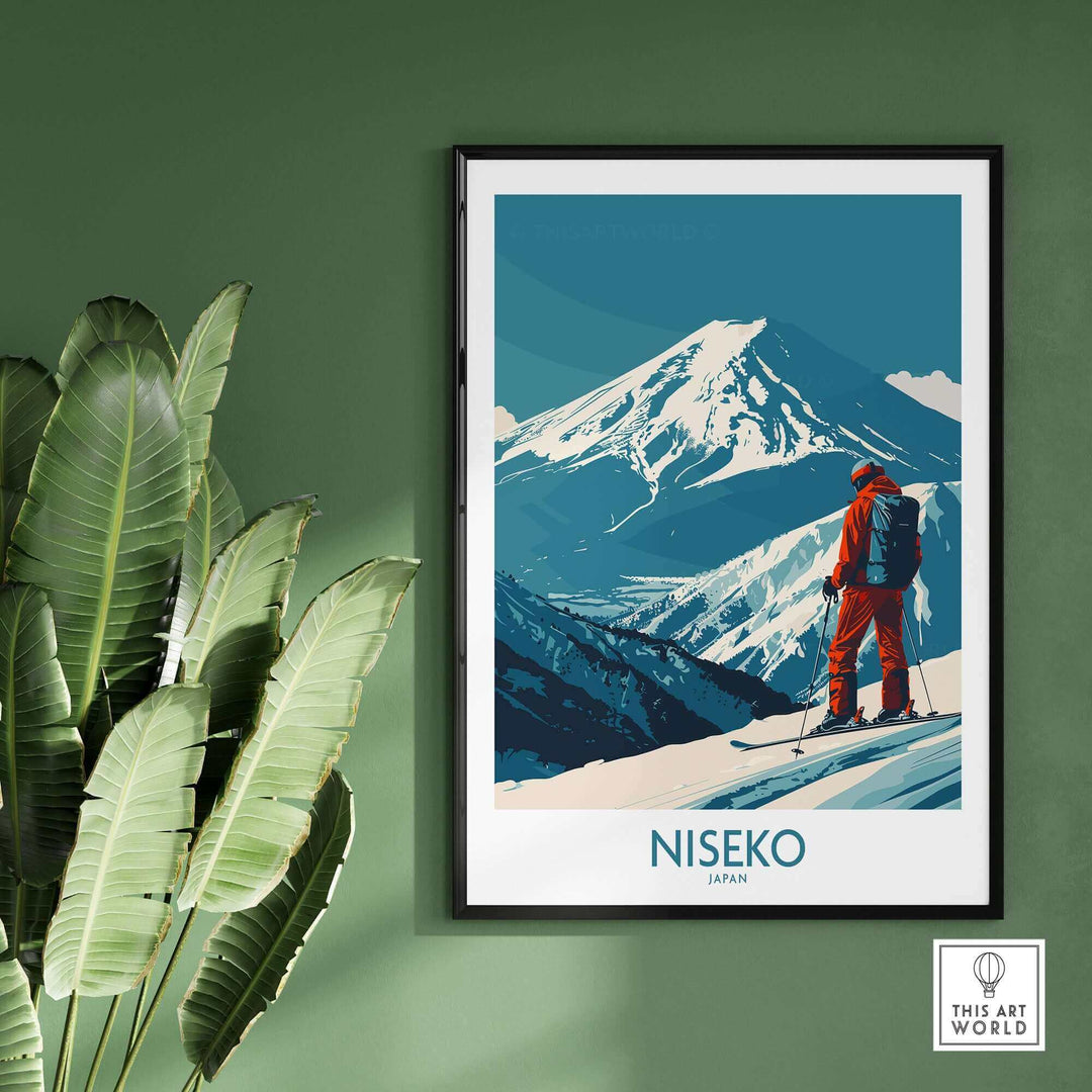 Skiing in Niseko art print featuring snow-capped mountain and skier in red against a vibrant blue sky, framed wall decor.