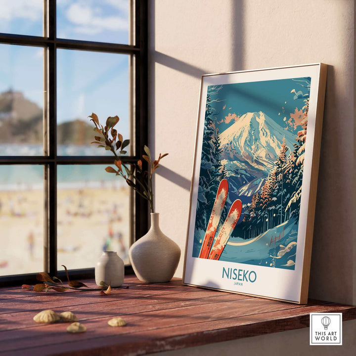 Stylish Niseko Japan poster featuring snowy mountains and skis, elegantly displayed on a windowsill with scenic background.