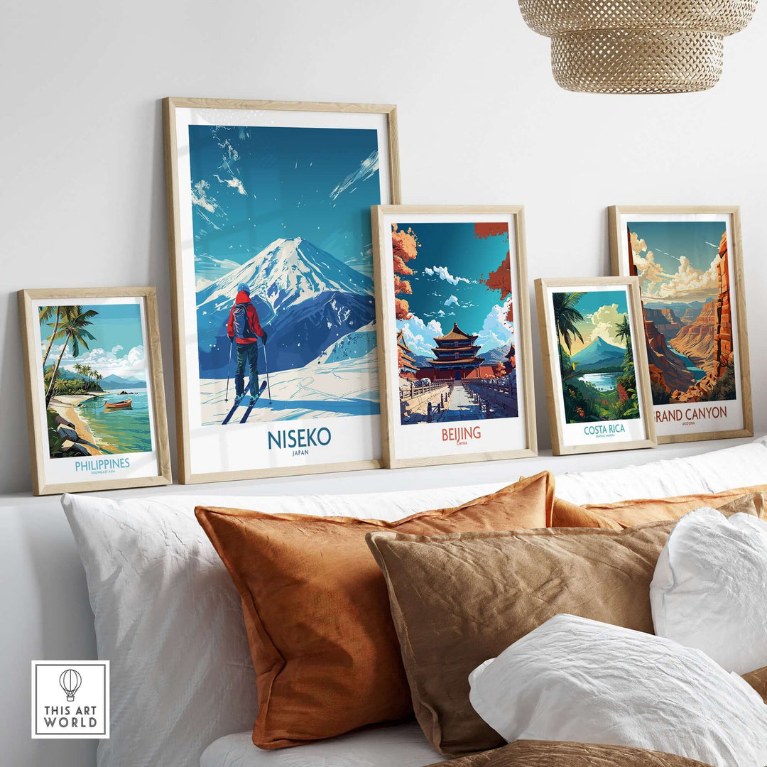 Collection of framed travel posters including Niseko ski scene and other global destinations, displayed on a sofa.