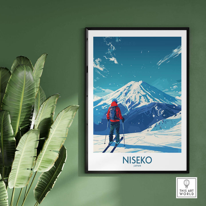 Niseko Ski Poster featuring a skier with a panoramic view of snowy Japanese mountains, framed and displayed on a green wall.