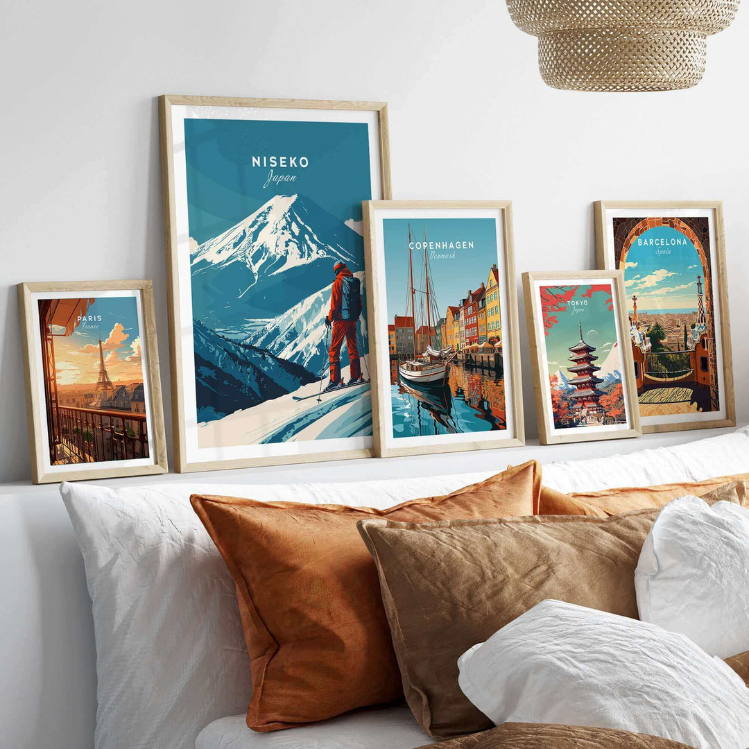 Niseko Japan ski poster wall art displayed with travel-themed artwork, featuring mountains and a skier, in a modern living room setting.