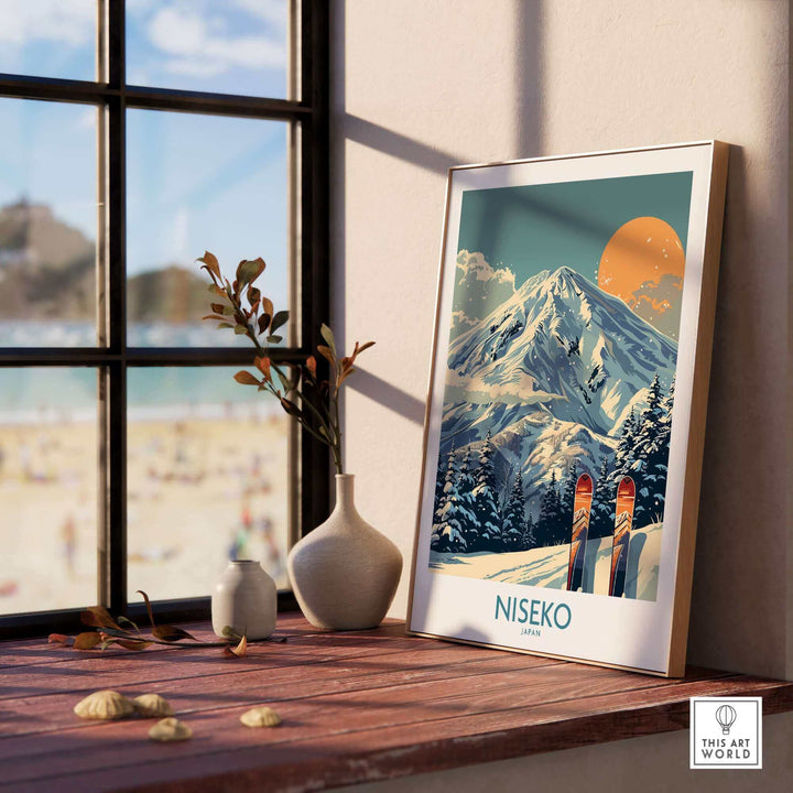 Niseko Wall Art Ski Poster on a sunlit windowsill with mountain scene and skis, perfect for ski enthusiasts and art lovers.